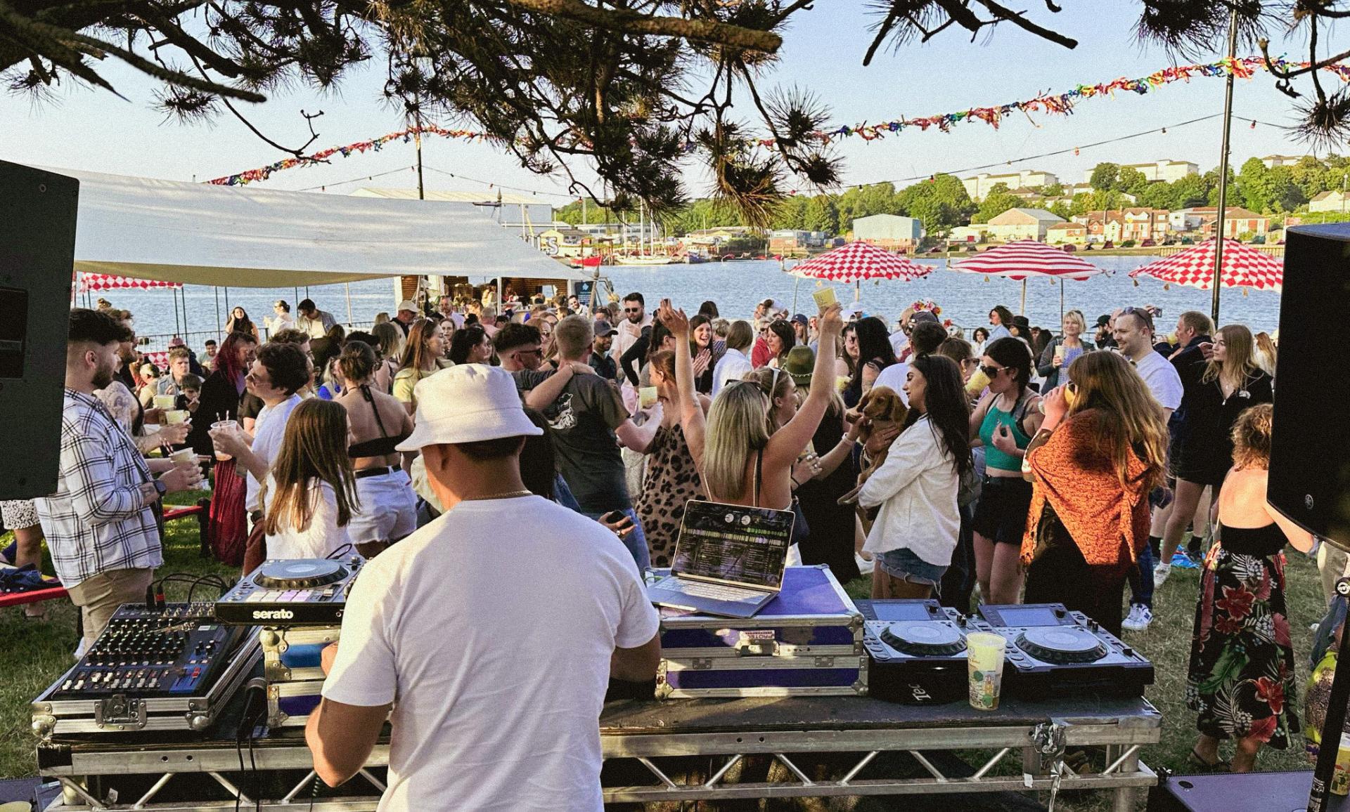 a dj playing the decks to a crowd