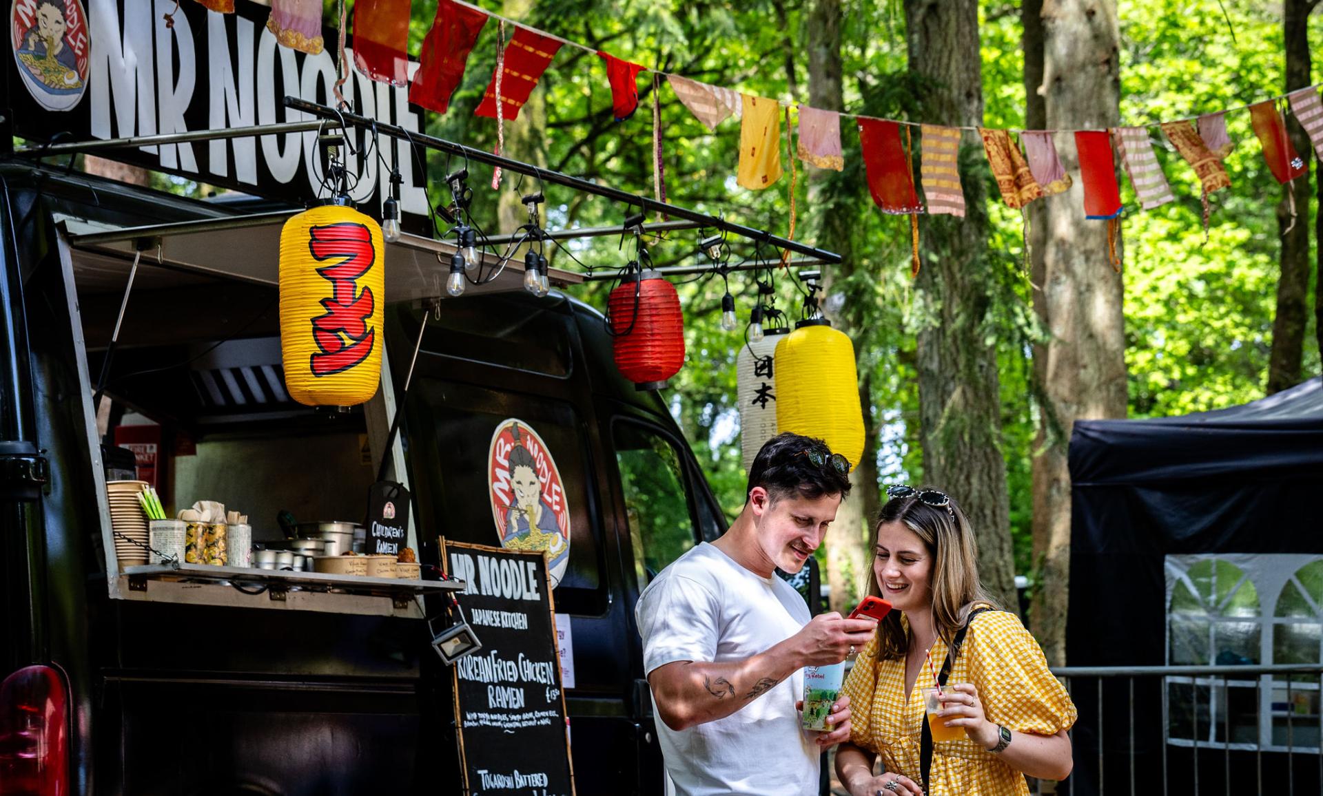 a couple in front of a vendor