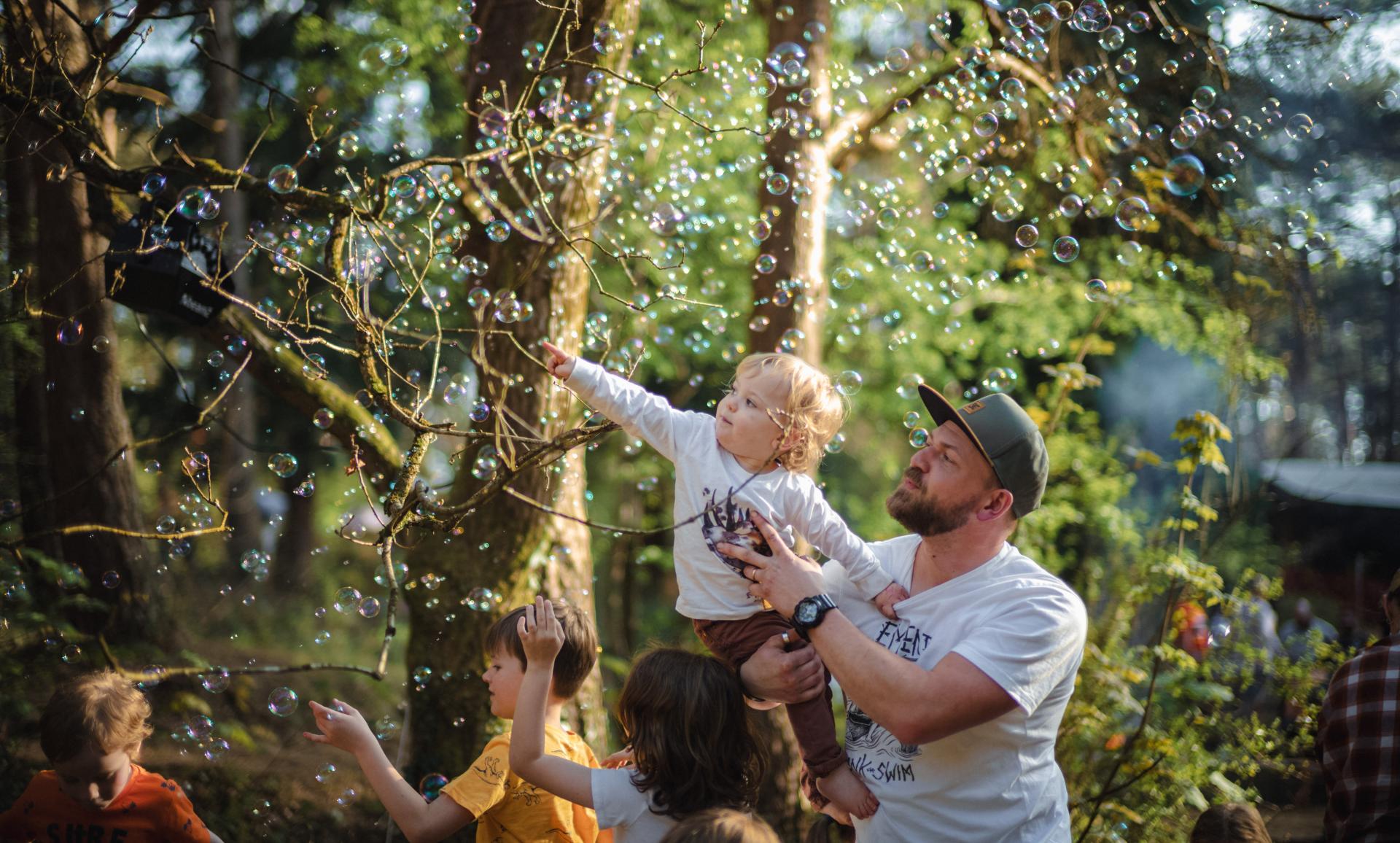 father and son playing with bubbles
